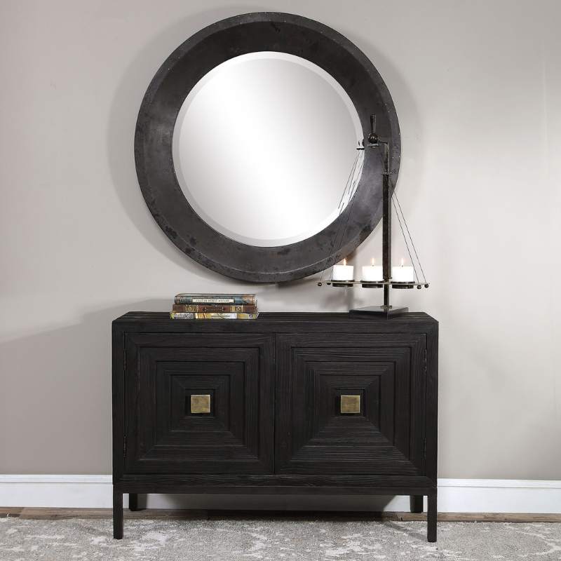 Large modern Round mirror above a 2 door black cabinet