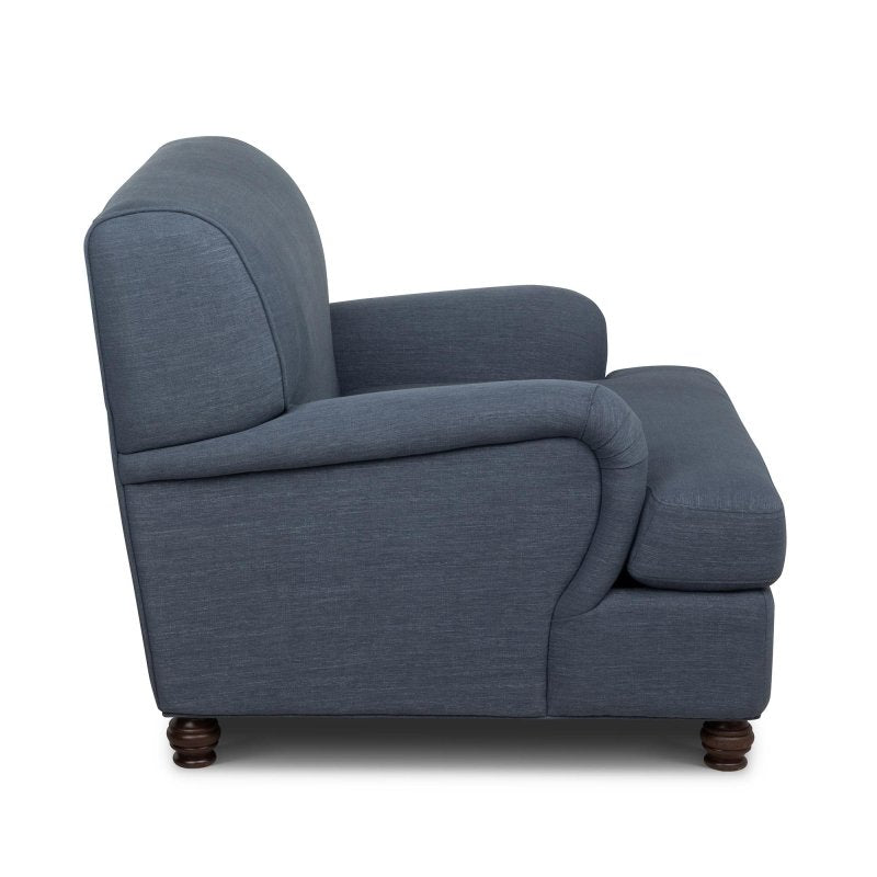 Side profile of the Kenwood heathered navy blue accent chair showing its rounded arm, cushioned seat and turned feet