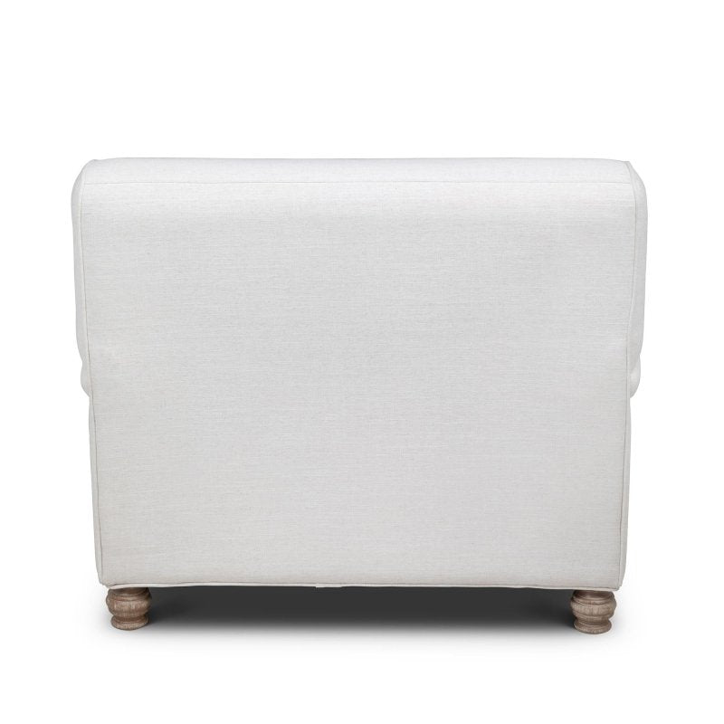 Rear view of the Kenwood ivory upholstered chair showing its tailored back and turned wood feet