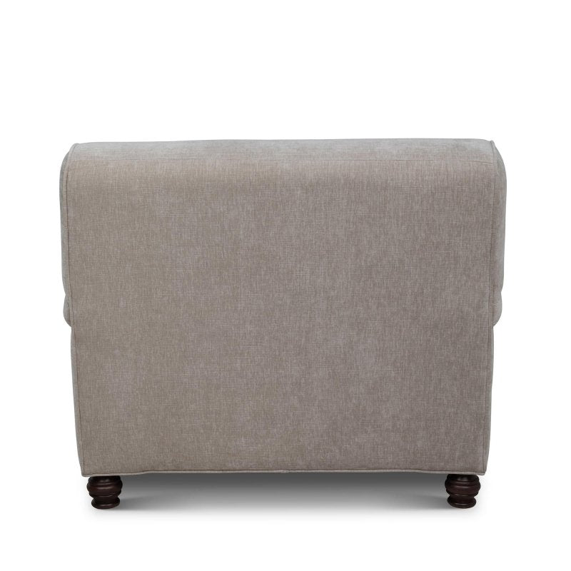 Rear view of the Kenwood putty gray upholstered chair showing its tailored back and turned wood feet