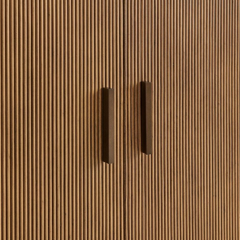 Close-up of the Mebarak cabinet reeded doors and bronze pulls