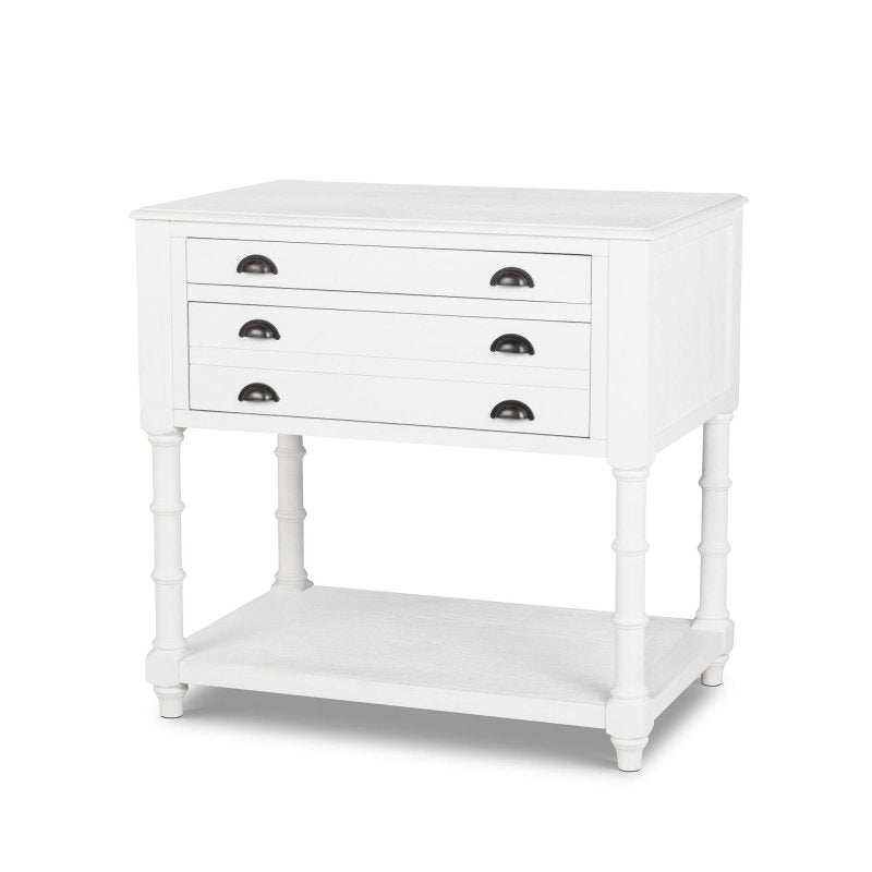 Three-quarter view of the Bimini whitewash kitchen island with three drawers, faux bamboo legs and a lower shelf