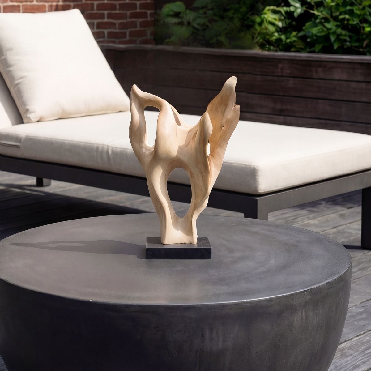 Hollow Form Teak Indoor-Outdoor Sculpture styled in an outdoor setting