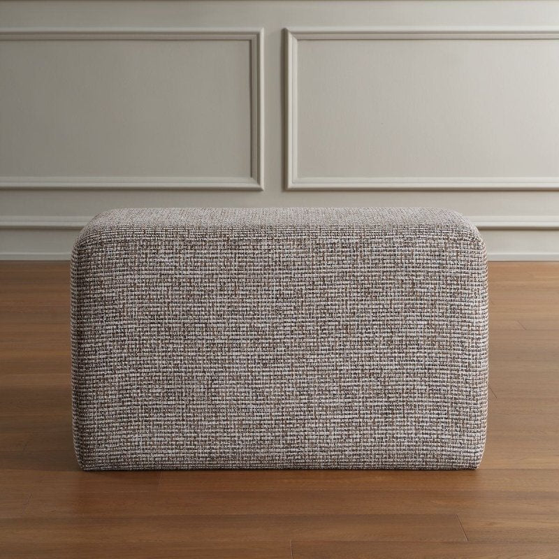 Detail view of the additional polyester upholstery detail on the Kelce Caramel Checkered Ottoman