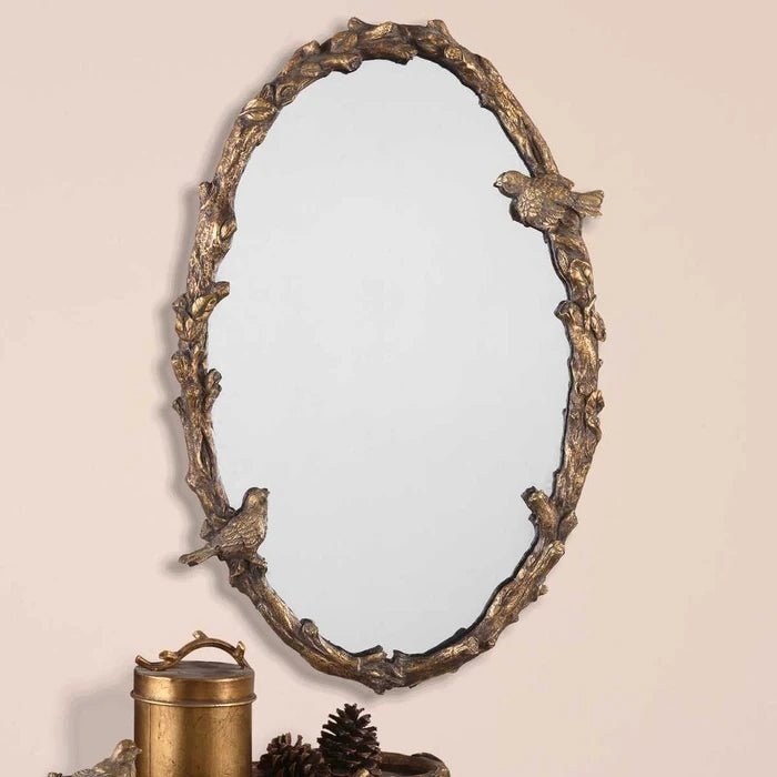 Paza Oval Mirror by Uttermost oval wall mirror angled view distressed gold leaf frame