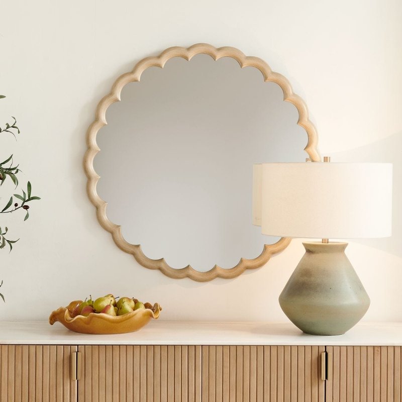 Cerrito Burnished Ivory Round Wall Mirror styled in an interior setting