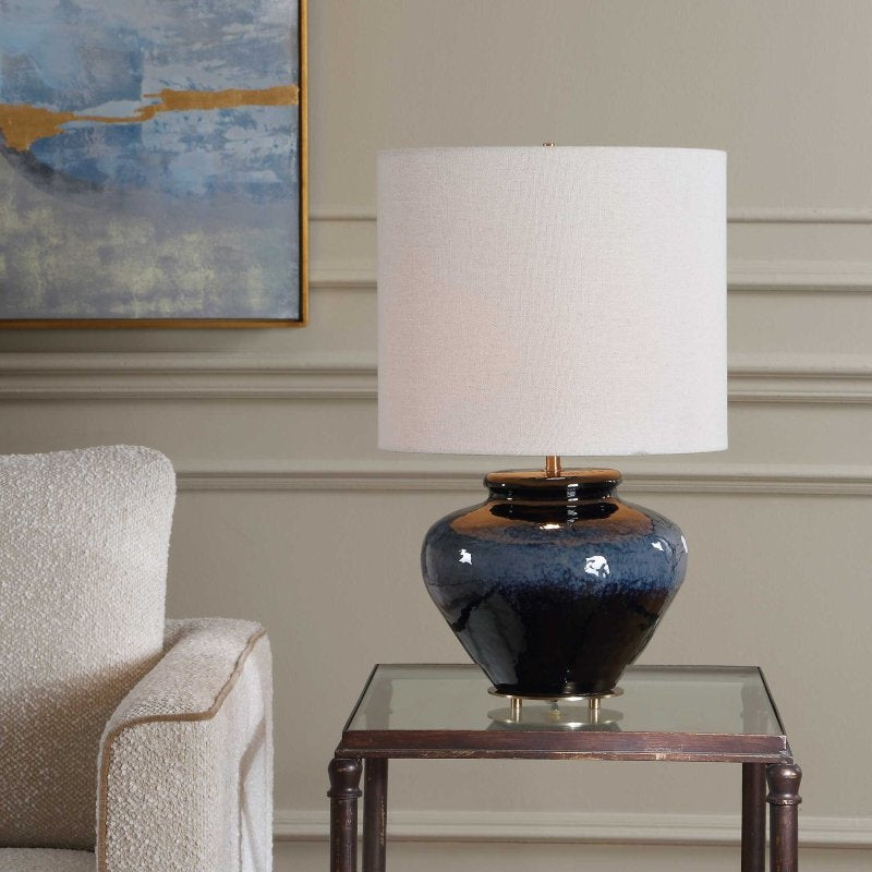 Lifestyle view 2 of Andrus Multitone Blue Ceramic Table Lamp in a living room side table beside a cream chair