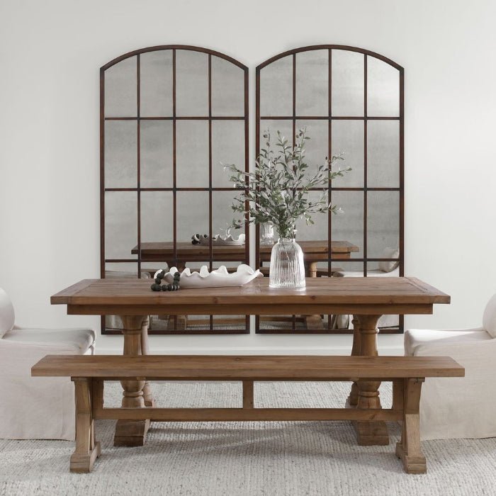 Arched and rectangular modern wall mirrors compared above a dining table in a styled living room.