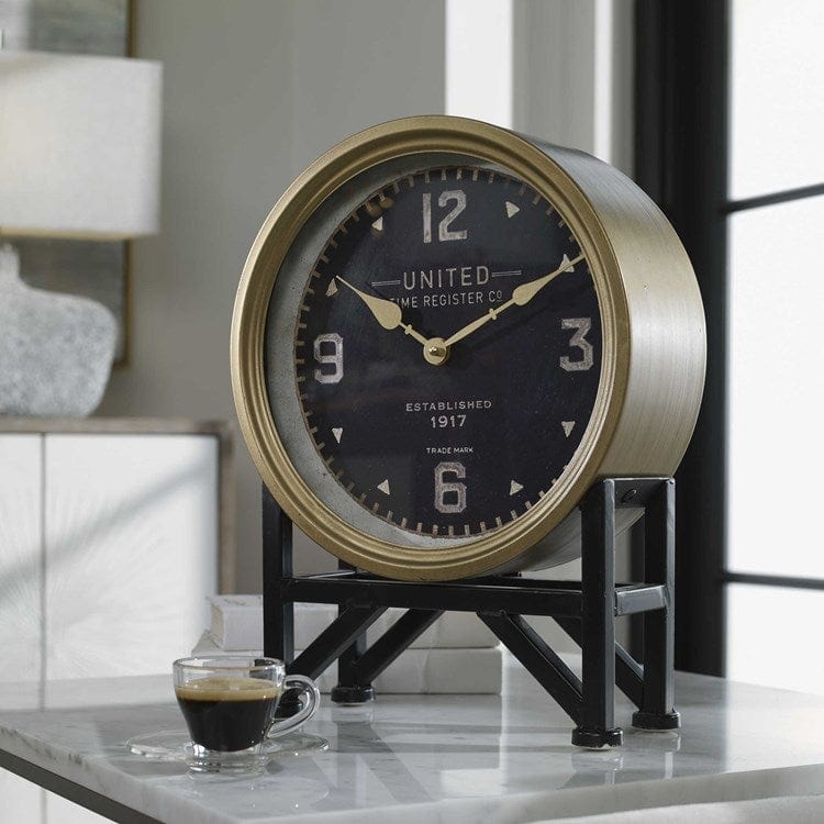 Torriana table clock with an aged black stand and brass-finish frame around a glass clock face