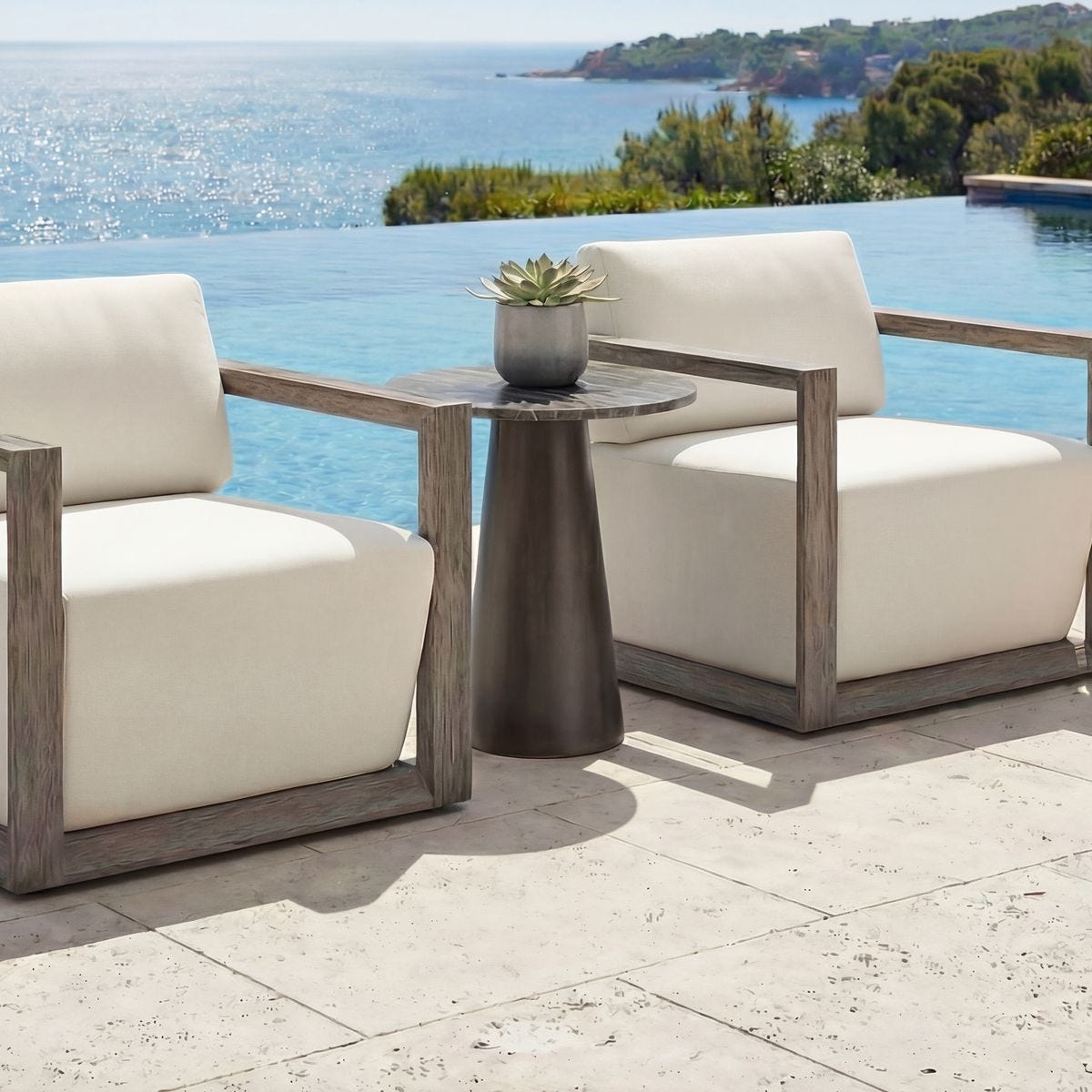 Midsummer bronze accent table styled on a patio by outdoor chairs
