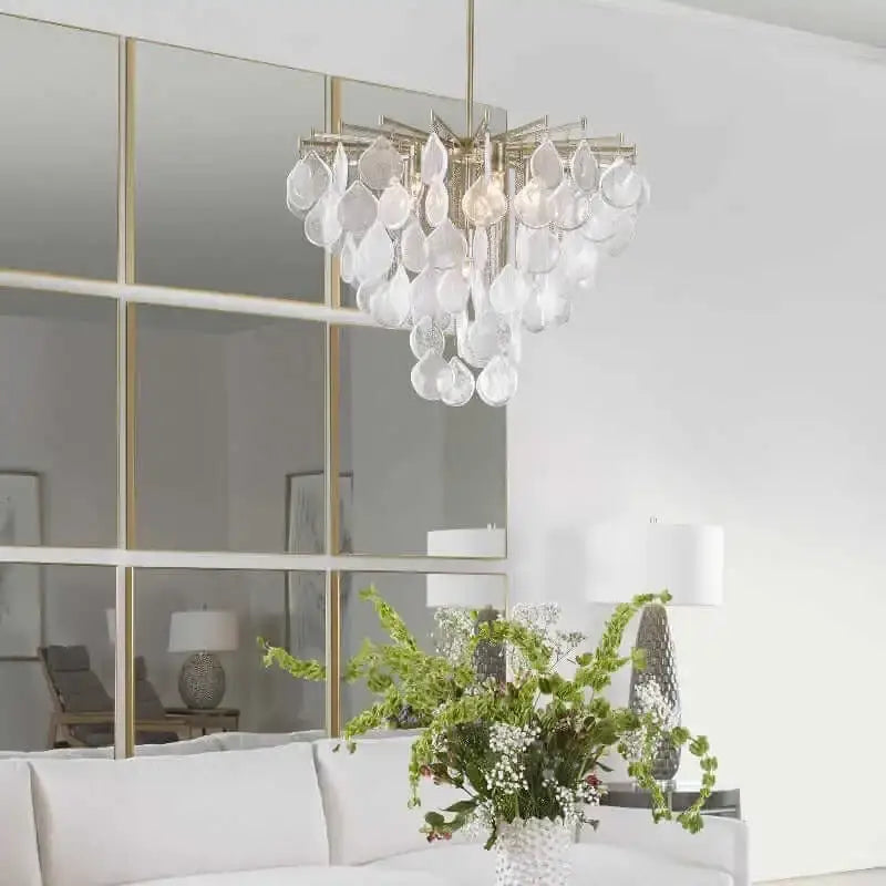 Chandelier with crystal accents in a room with a mirror and decor elements.