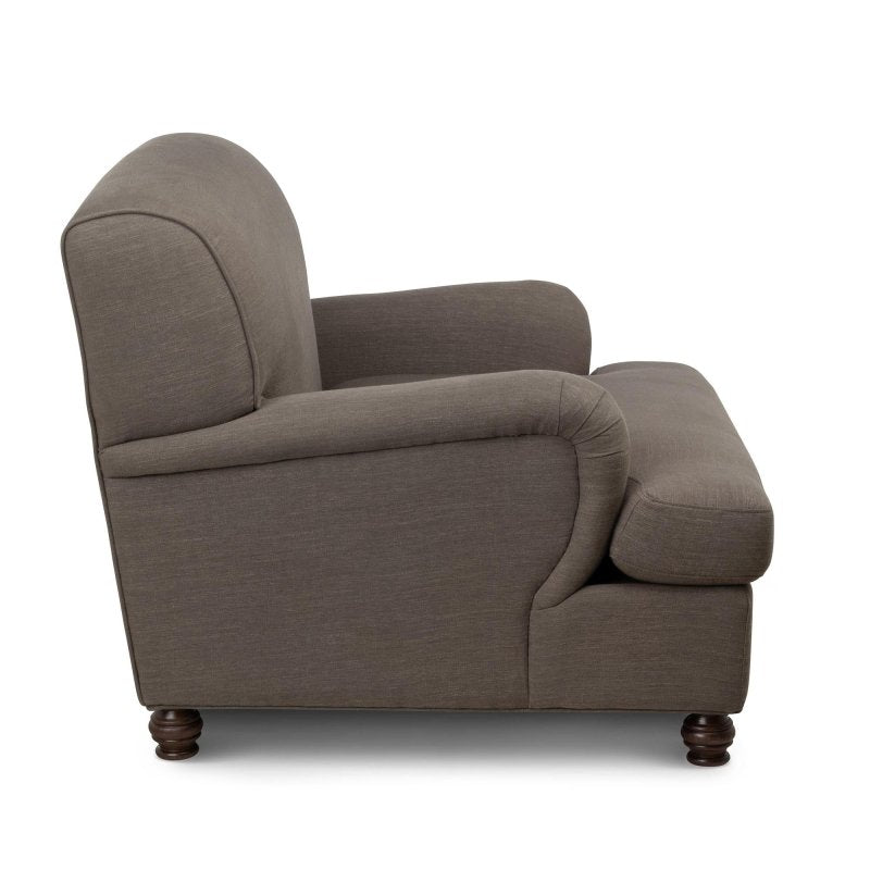 Side profile of the Kenwood mocha brown accent chair showing its rounded arm, cushioned seat and turned feet