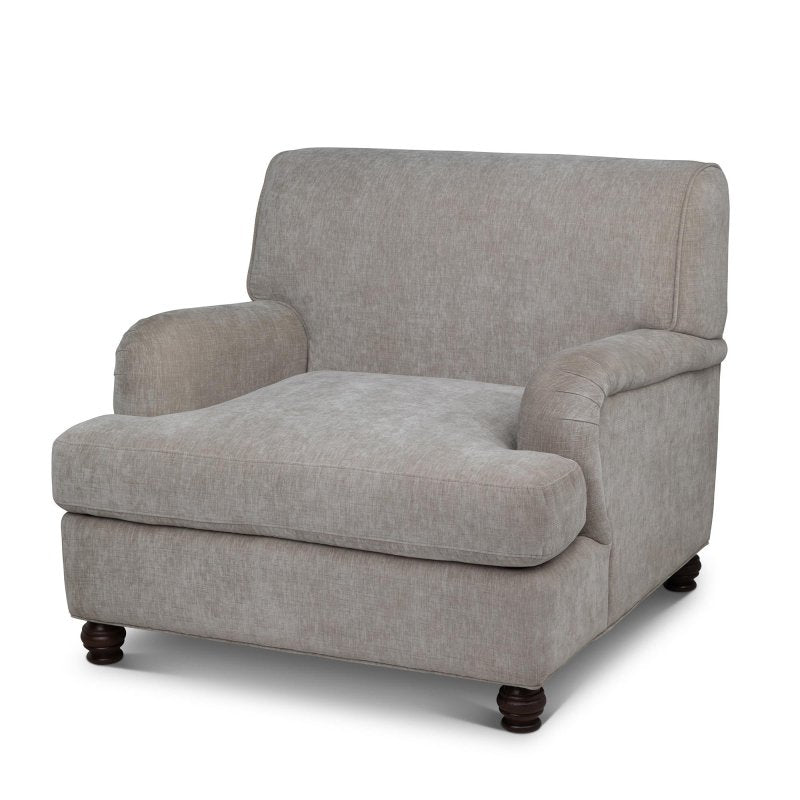 Three-quarter view of the Kenwood putty gray upholstered accent chair with a loose seat cushion and turned wood feet