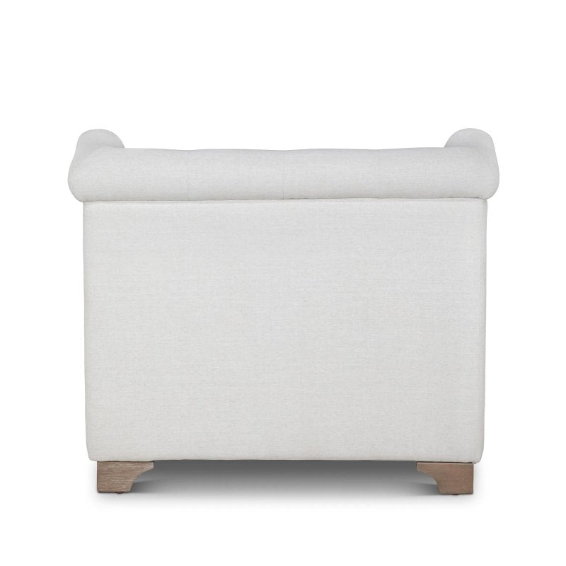 Rear view of the Scroll Arm ivory upholstered chair showing its tailored back and rolled crest