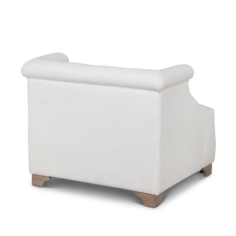 Rear three-quarter view of the Scroll Arm ivory accent chair with an upholstered back and wood block feet