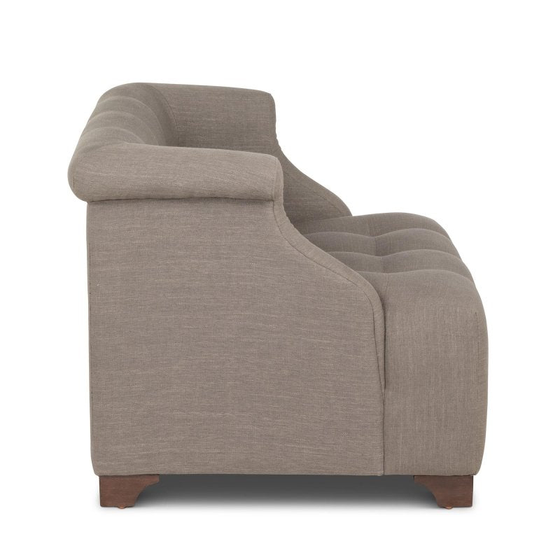 Side profile of the Scroll Arm mocha brown chair showing its rolled arm, deep tufted seat and wood feet