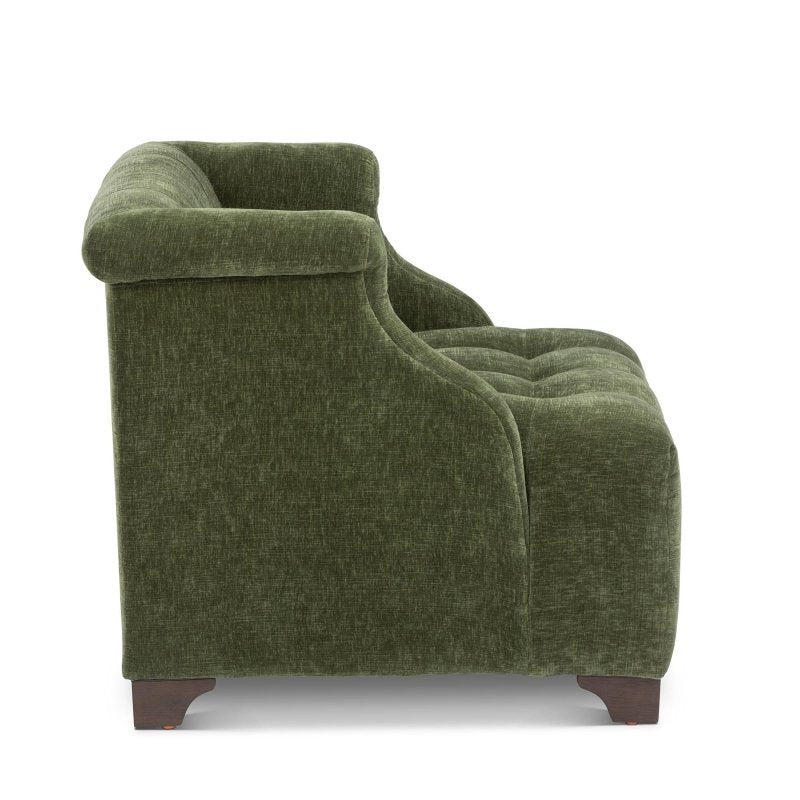Side profile of the Scroll Arm moss green chair showing its rolled arm, deep tufted seat and wood feet