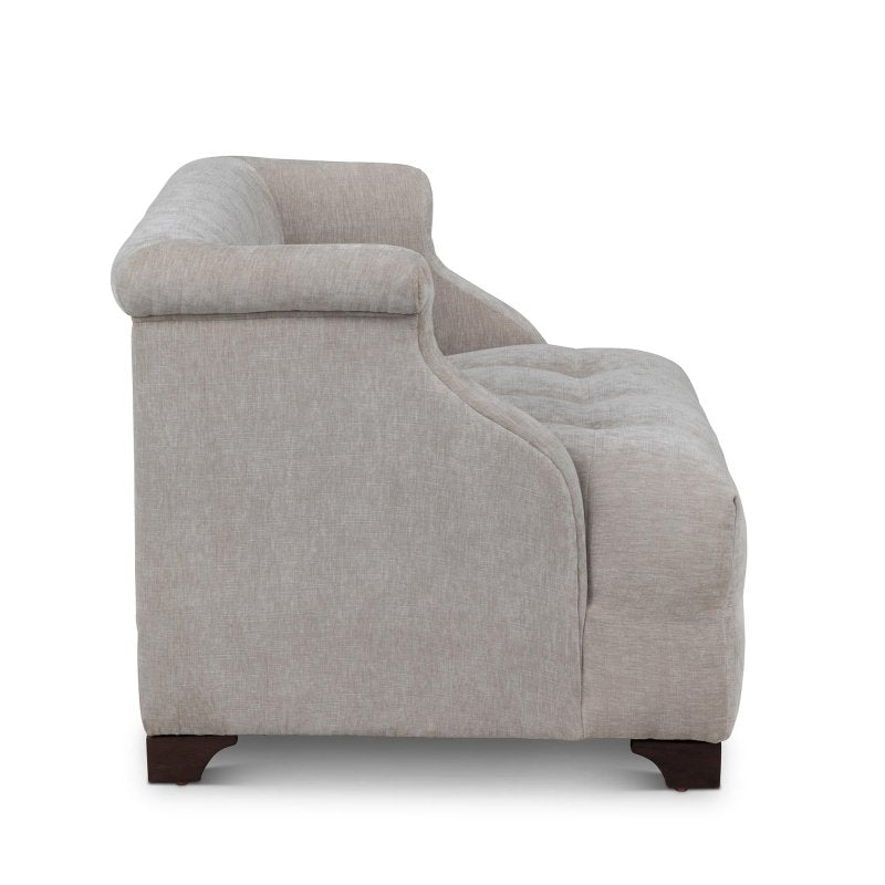Side profile of the Scroll Arm putty gray chair showing its rolled arm, deep tufted seat and wood feet