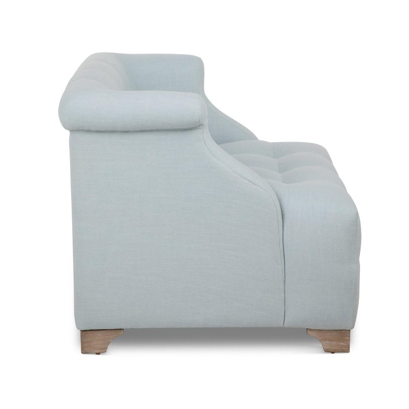 Side profile of the Scroll Arm Serene Sky blue chair showing its rolled arm, deep tufted seat and wood feet