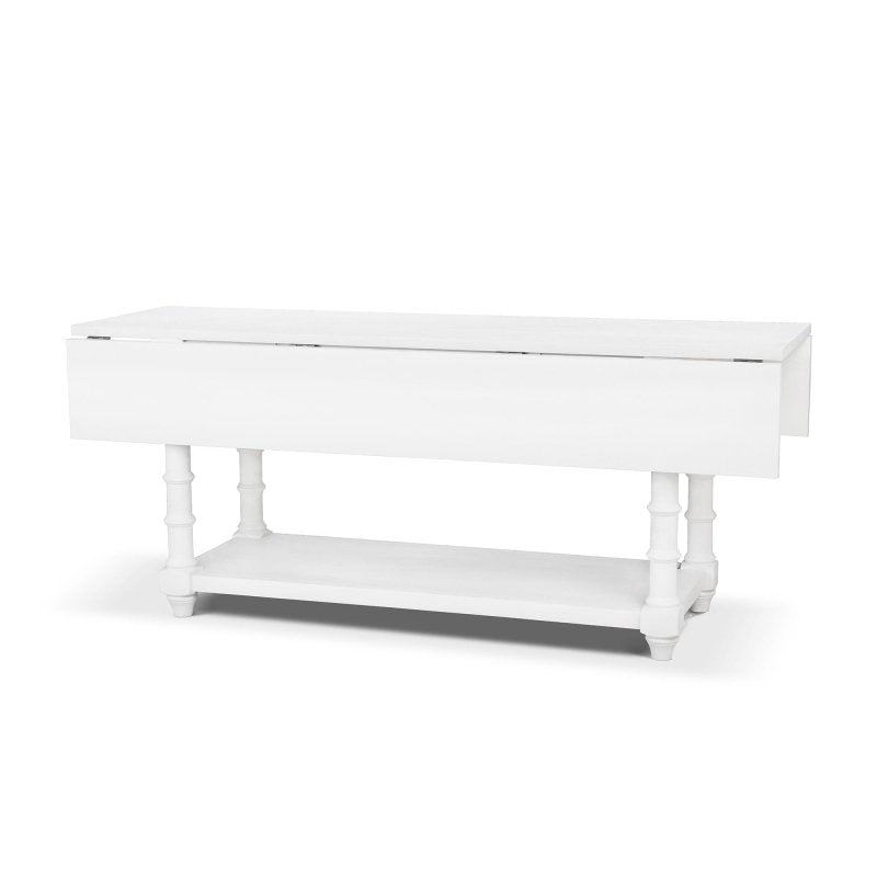 Three-quarter view of the Bimini whitewash dining table with both drop leaves lowered for a narrow profile