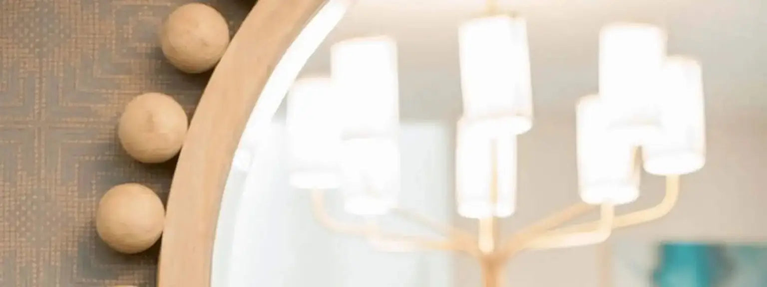 Modern chandelier with wooden spherical accents on a textured wall.