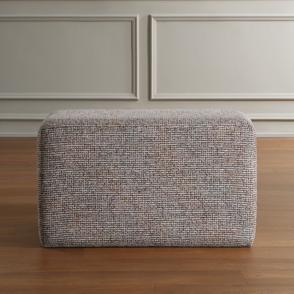 Detail view of the additional polyester upholstery detail on the Kelce Caramel Checkered Ottoman
