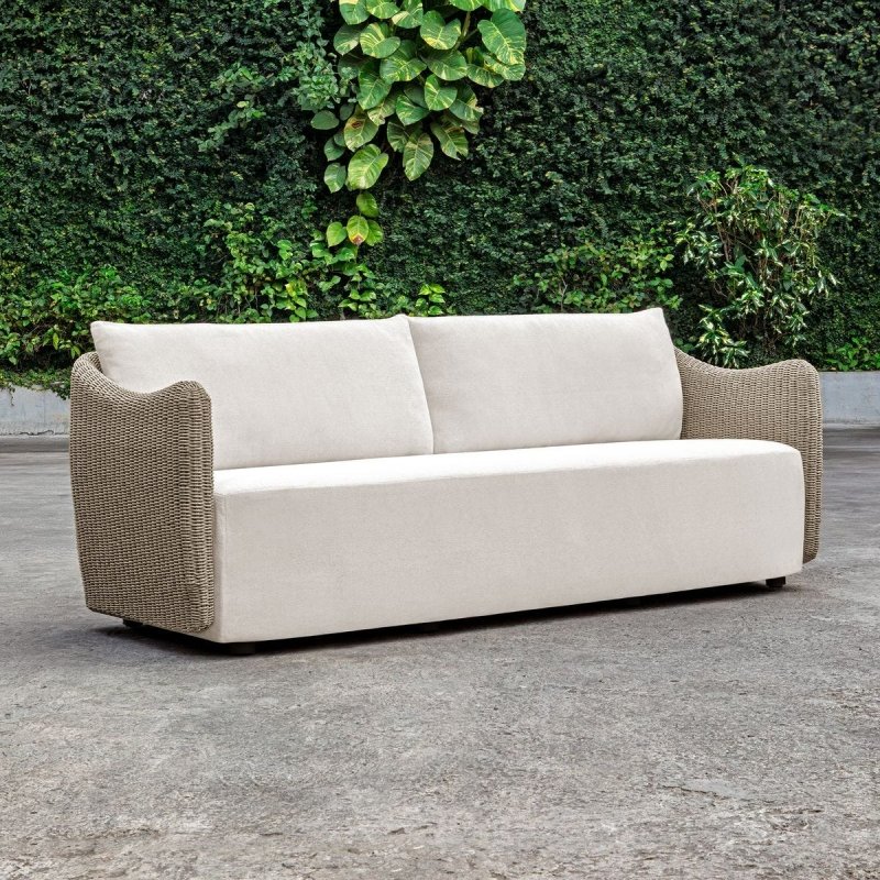 Sunset outdoor sofa shown against greenery
