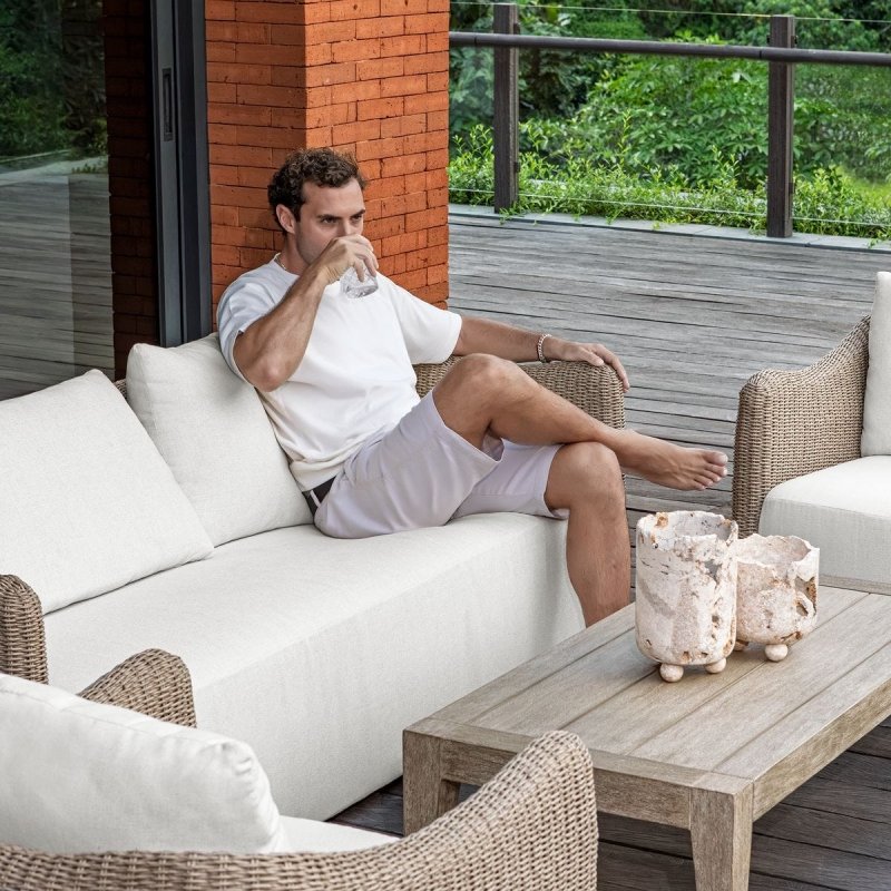 Sunset outdoor sofa shown in use on a patio