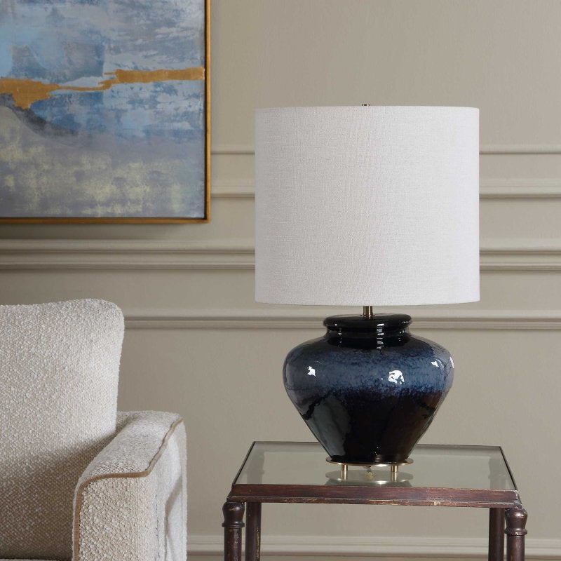Lifestyle view 3 of Andrus Multitone Blue Ceramic Table Lamp in a living room side table beside a cream chair