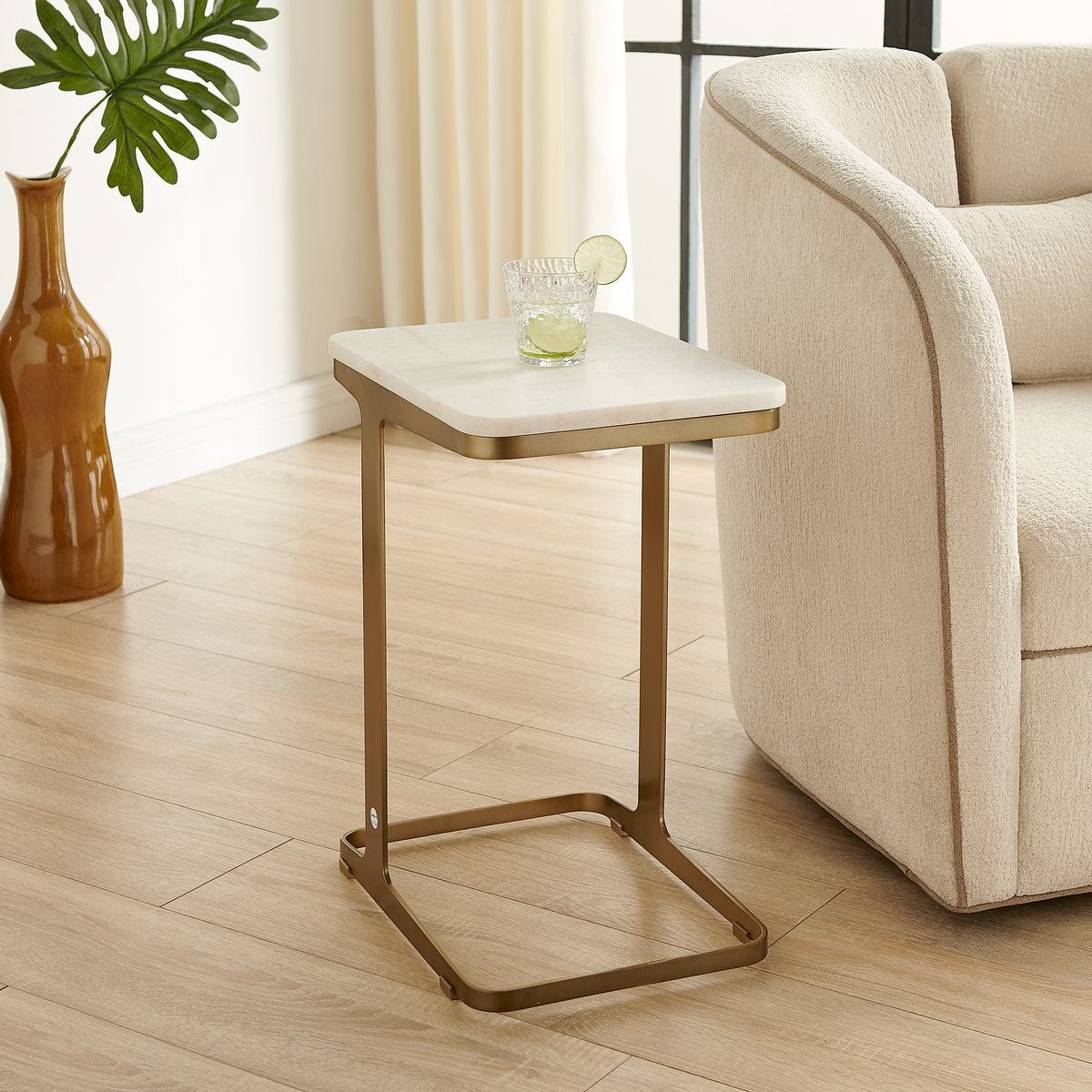 Tylan Brass and White Marble Accent Table styled in a room setting