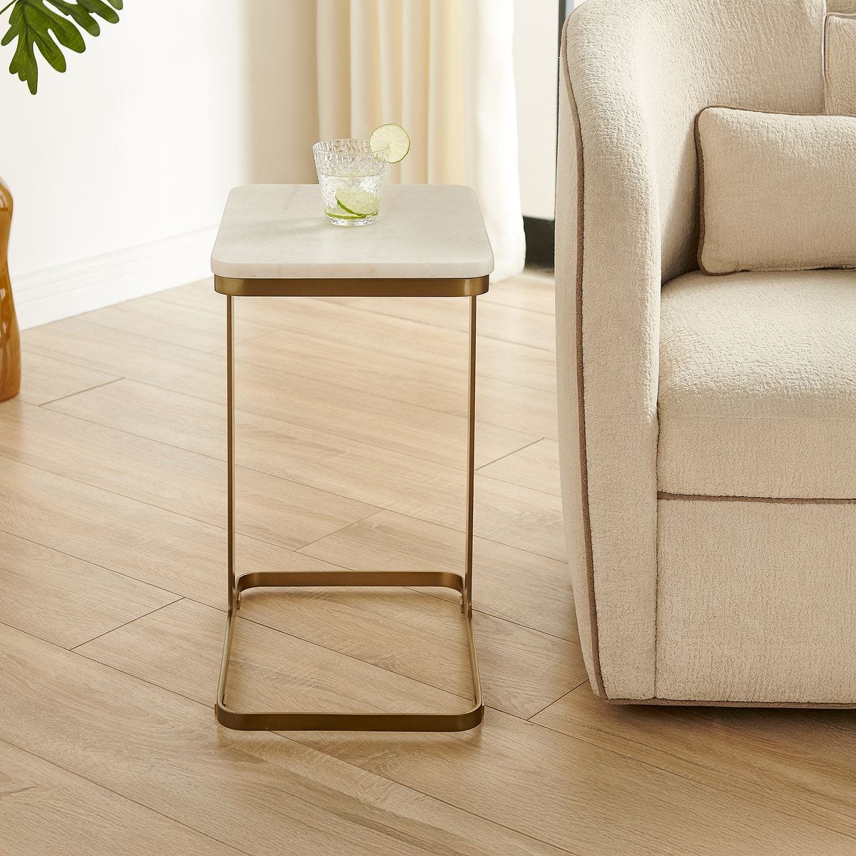 Side view of the Tylan Brass and White Marble Accent Table by Uttermost