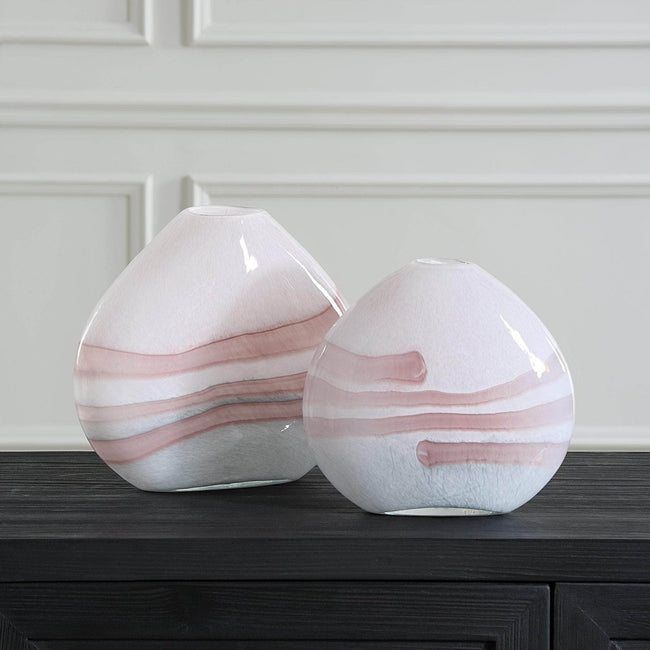 Blush pink swirl glass vases styled on console table in contemporary living room
